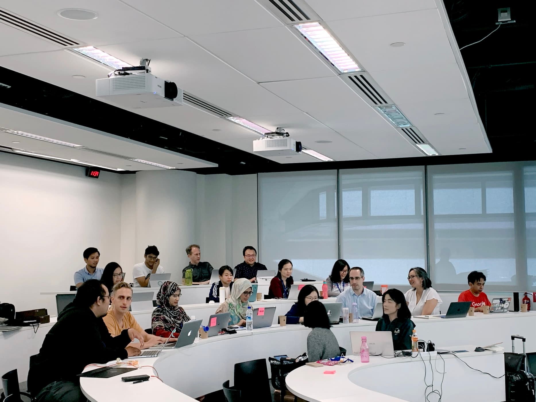 Groups of students in a lecture hall together