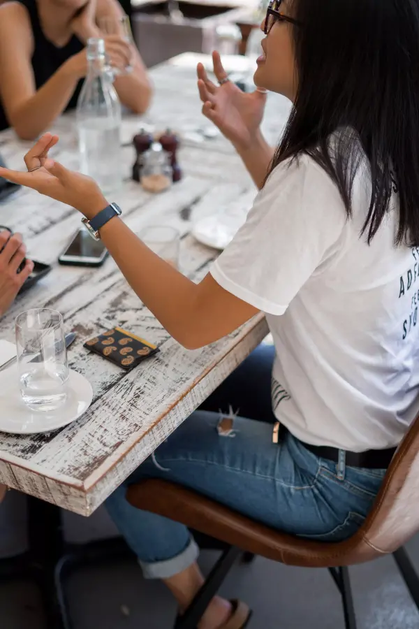 People having a conversation at a dinner table