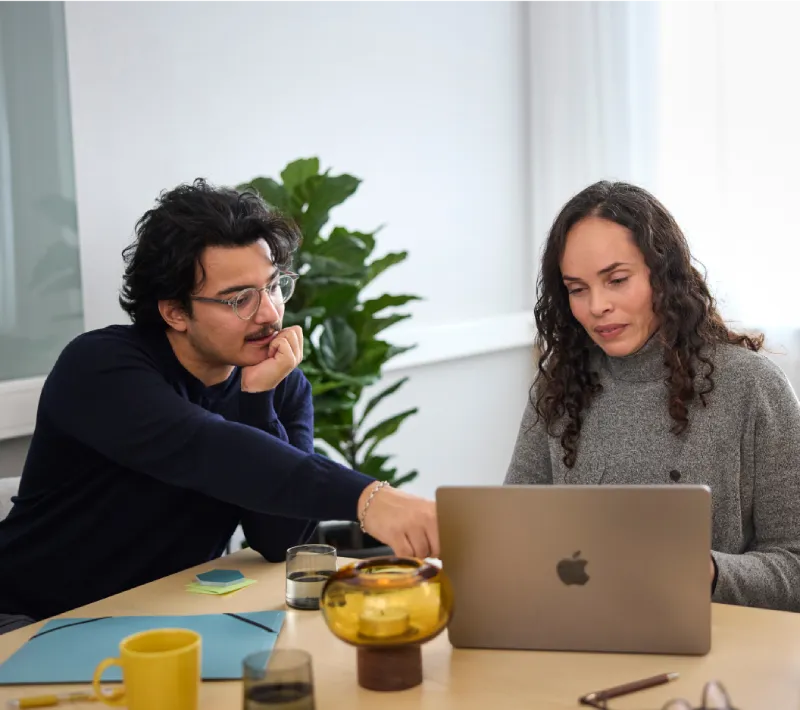 A man and a woman looking on a laptop.