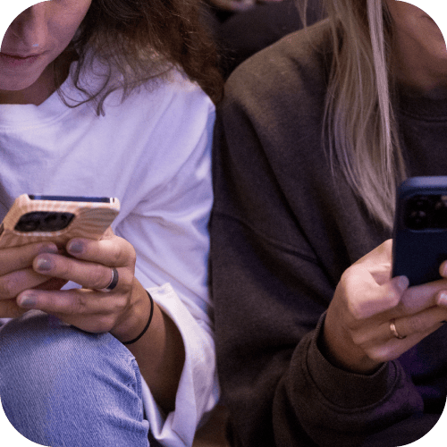 Two people looking at their phones