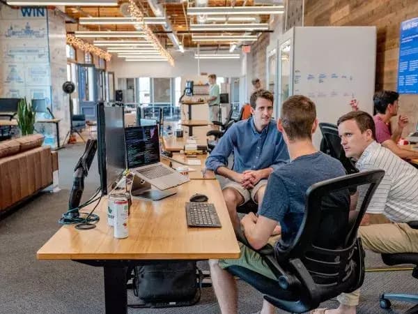People sitting by a desk talking