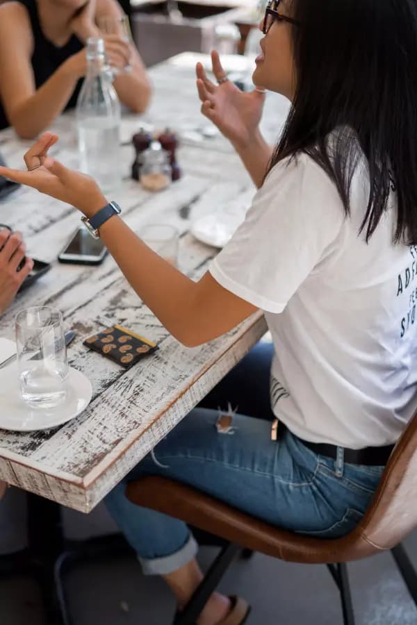 People having a conversation at a dinner table