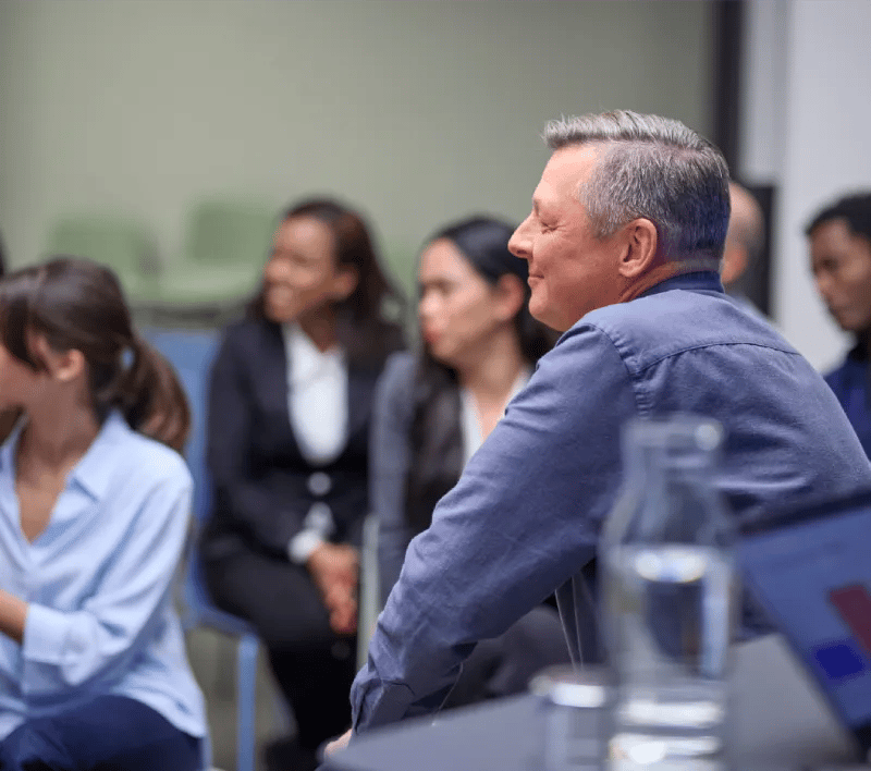 A man in profile smiling