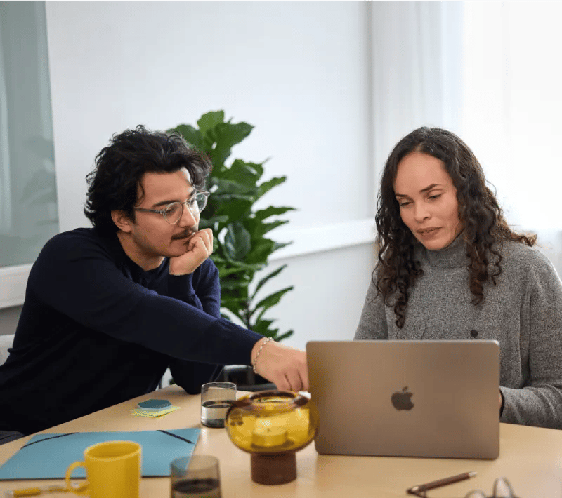 A man and a woman looking on a laptop.